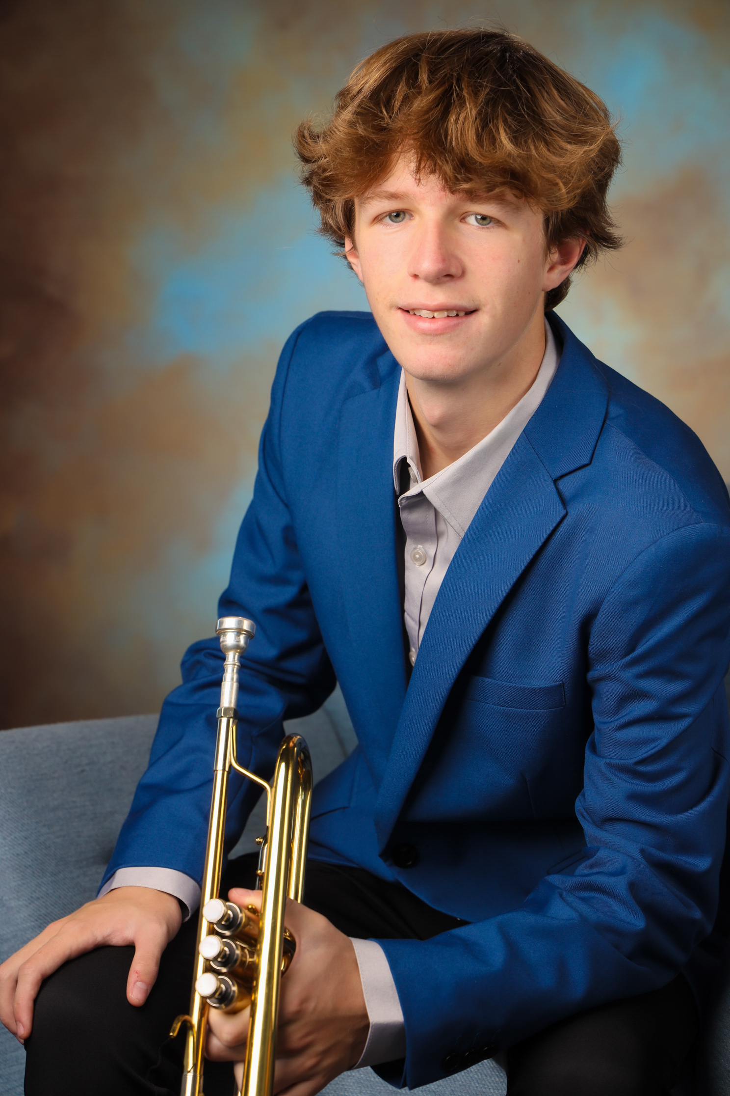 Kyle Cox holding Trumpet